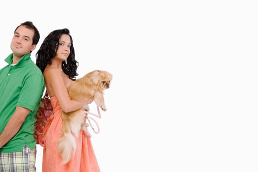 Side profile of a young woman holding a dog with a young man beside her