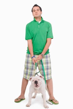 Portrait of a young man standing with a dog
