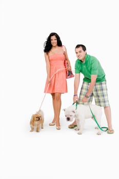 Portrait of a young couple standing with dogs