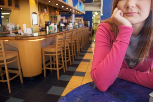 Close-up of a young woman sitting in a bar