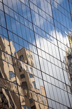 Reflection of a building on the window glass of an office building