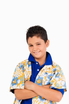 Portrait of a boy standing with his arms crossed and smiling