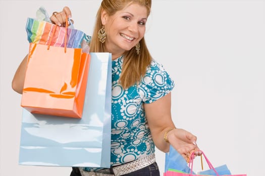Portrait of a mature woman holding shopping bags and smiling