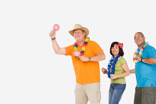 Two mature men and a senior woman dancing together