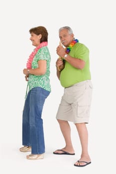 Senior man playing ukulele with a senior woman dancing in front of him