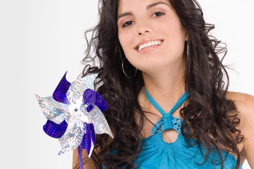 Portrait of a teenage girl holding a pinwheel and smiling