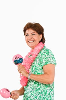 Side profile of a senior woman playing maracas and smiling