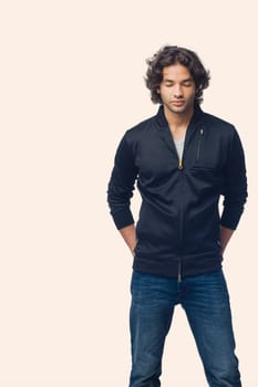Young man standing with his hands in his pockets