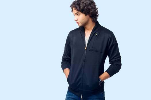 Young man standing with his hands in his pockets