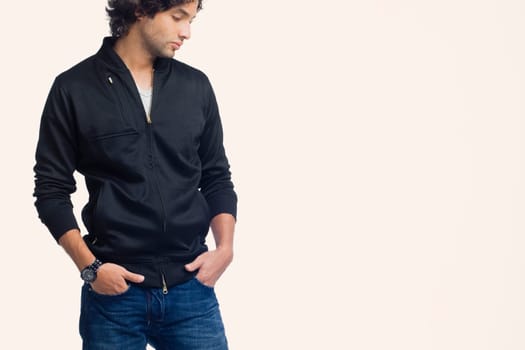 Young man standing with his hands in his pockets