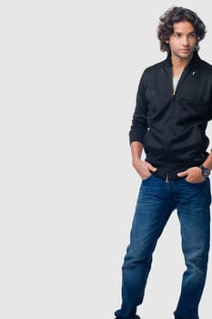 Young man standing with his hands in his pockets