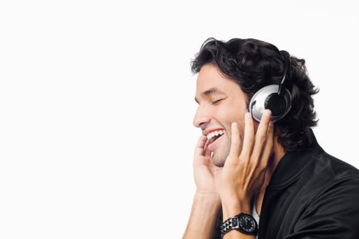 Close-up of a young man listening to music and smiling