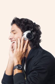 Close-up of a young man listening to music and smiling