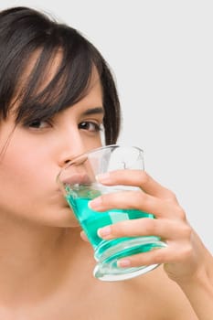 Portrait of a young woman gargling