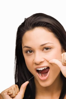 Portrait of a young woman flossing her teeth