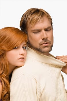 Portrait of a young woman resting her face on the shoulder of a mid adult man