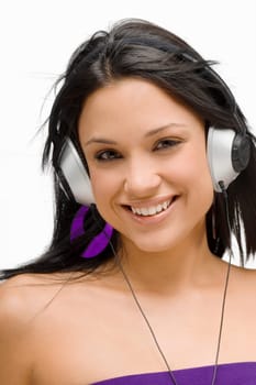 Portrait of a young woman wearing headphones and listening to music