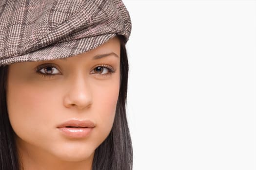 Portrait of a young woman wearing a flat cap