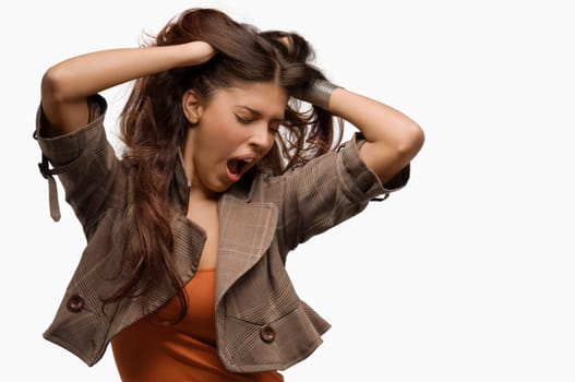 Close-up of a young woman yawning and her hands in her hair