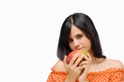 Portrait of a young woman holding a mango