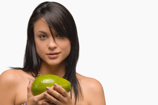 Portrait of a young woman holding an avocado