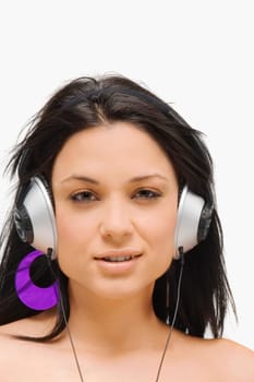 Portrait of a young woman wearing headphones and listening to music