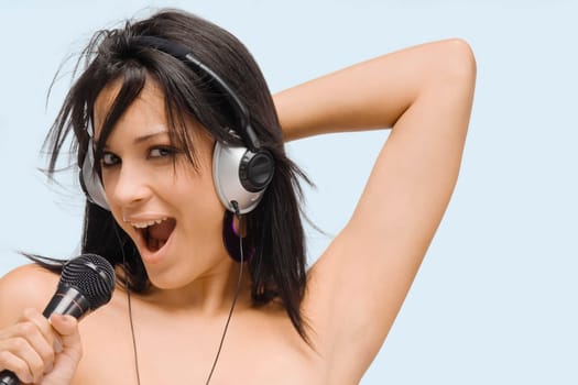 Portrait of a young woman singing into a microphone