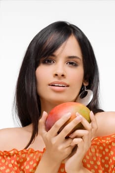 Portrait of a young woman holding a mango