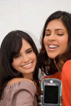 Two young women taking a photograph of themselves