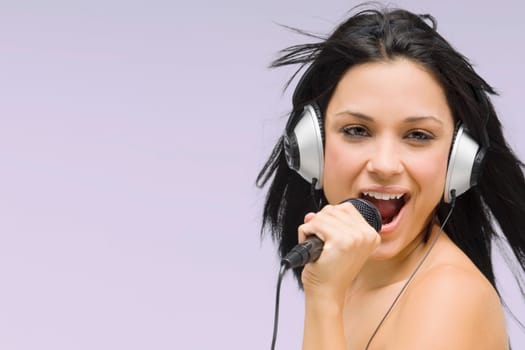 Close-up of a young woman singing into a microphone
