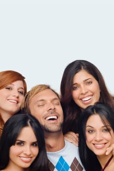 Close-up of a mid adult man posing with four young women