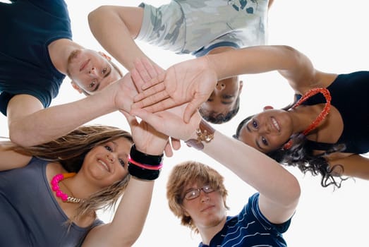 Low angle view of five friends stacking their hands
