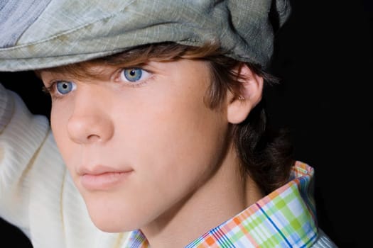 Close-up of a teenage boy wearing a flat cap