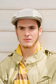Close-up of a young man wearing a flat cap