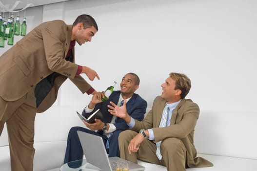 Three businessmen celebrating together