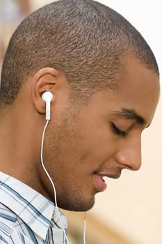 Side profile of a young man listening to music