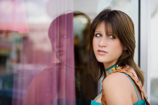 Side profile of a young woman window shopping