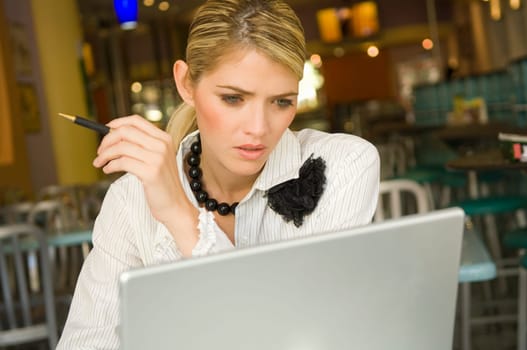 Businesswoman using a laptop in a restaurant