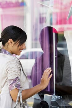 Side profile of a young woman window shopping