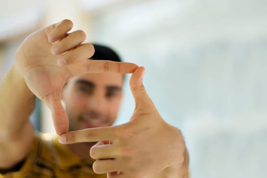 Young man making a finger frame