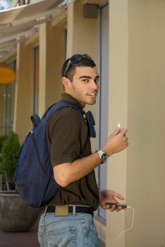 Portrait of a young man listening to an MP3 player