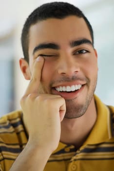 Portrait of a young man pointing his eye
