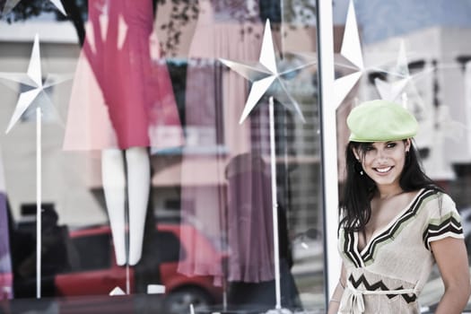 Young woman smiling in front of a clothing store