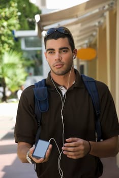 Young man listening to an MP3 player