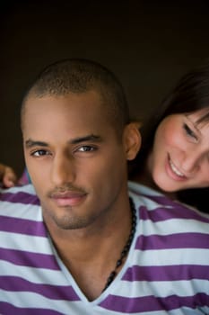 Portrait of a young man with a young woman smiling