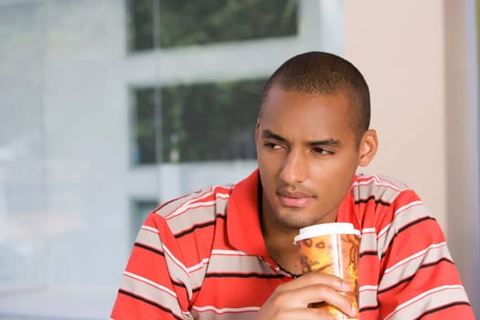 Close-up of a young man drinking coffee
