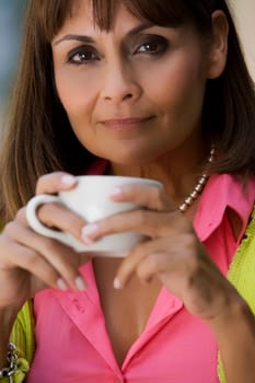 Portrait of a mature woman holding a cup of coffee