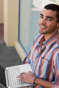 Portrait of a young man using a laptop
