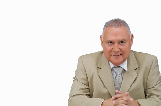 Portrait of a businessman sitting with his hands clasped