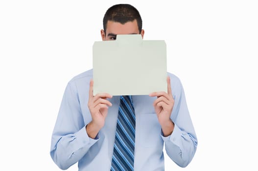 Portrait of a businessman holding a placard in front of his face